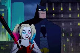 Harley Quinn and Batman standing on a rooftop